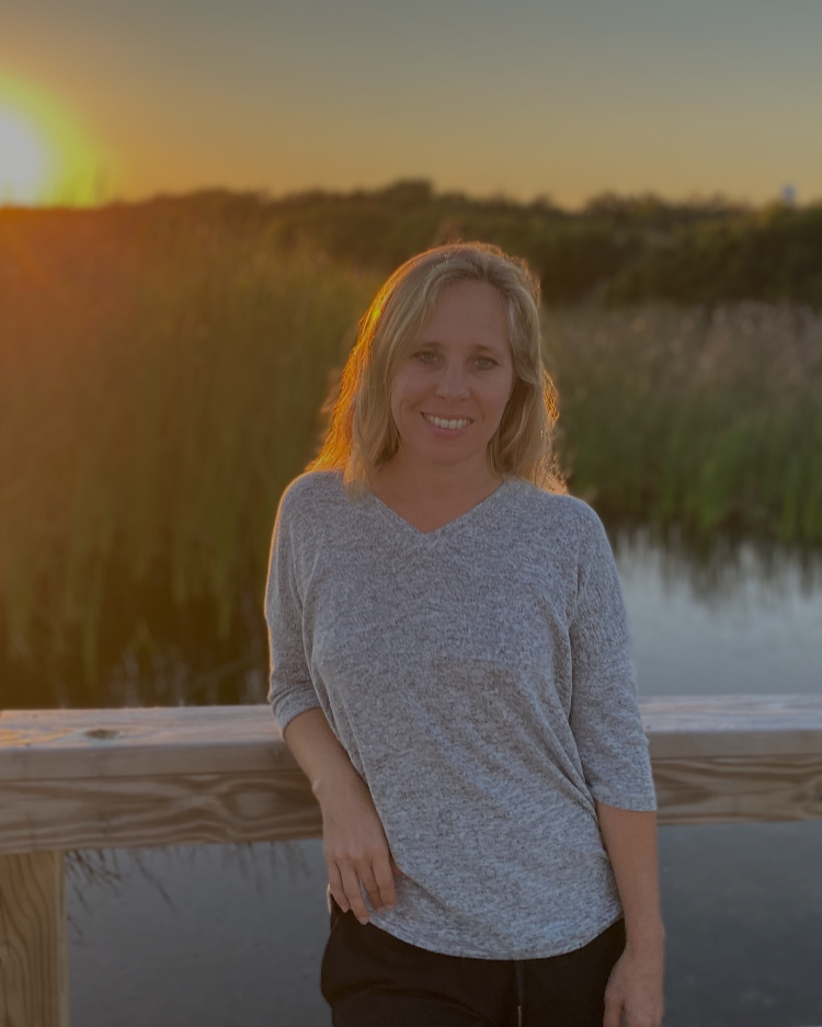 Portrait of Erin Pickus on a lowcountry boardwalk at golden hour